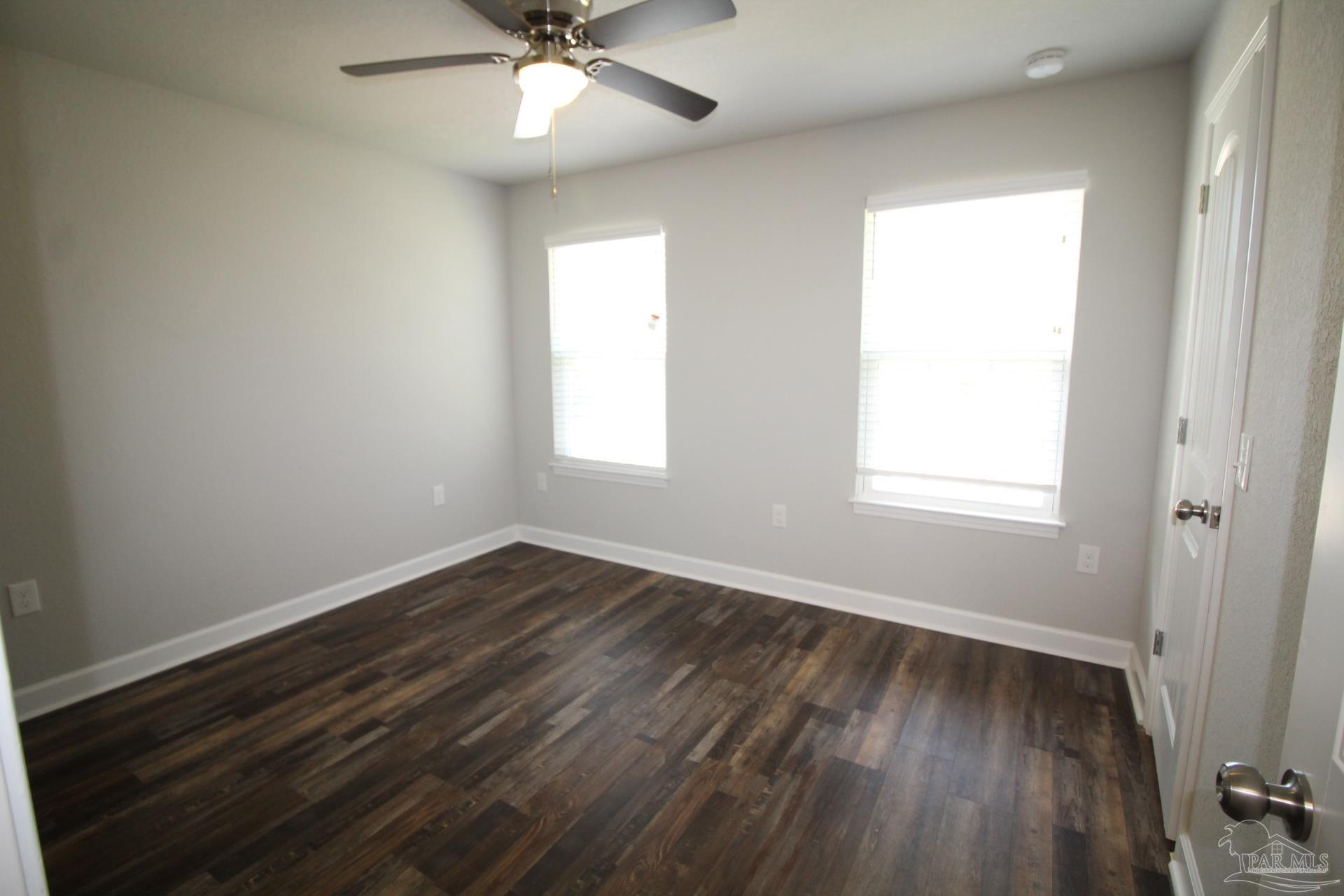 150 South Crow Road, Unit 1501 Pensacola, FL 32506 - Photo 10 of 12 wooden floor in an empty room with a window