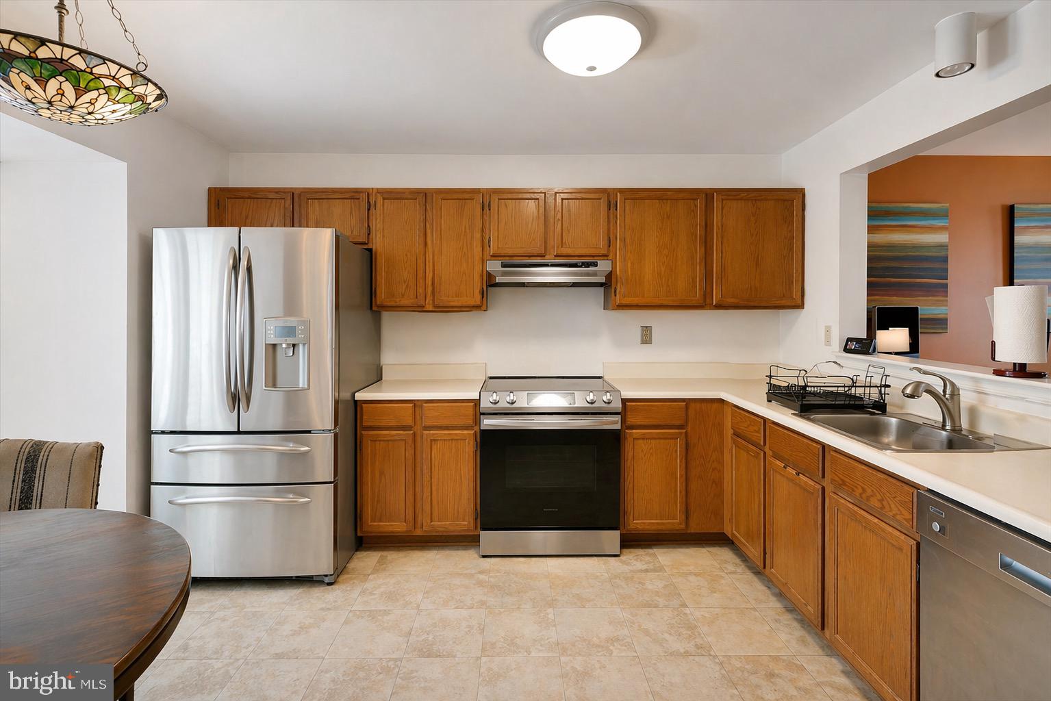 10983 Baskerville Road Reisterstown, MD 21136 - Photo 2 of 21 a kitchen with stainless steel appliances granite countertop a refrigerator sink and stove