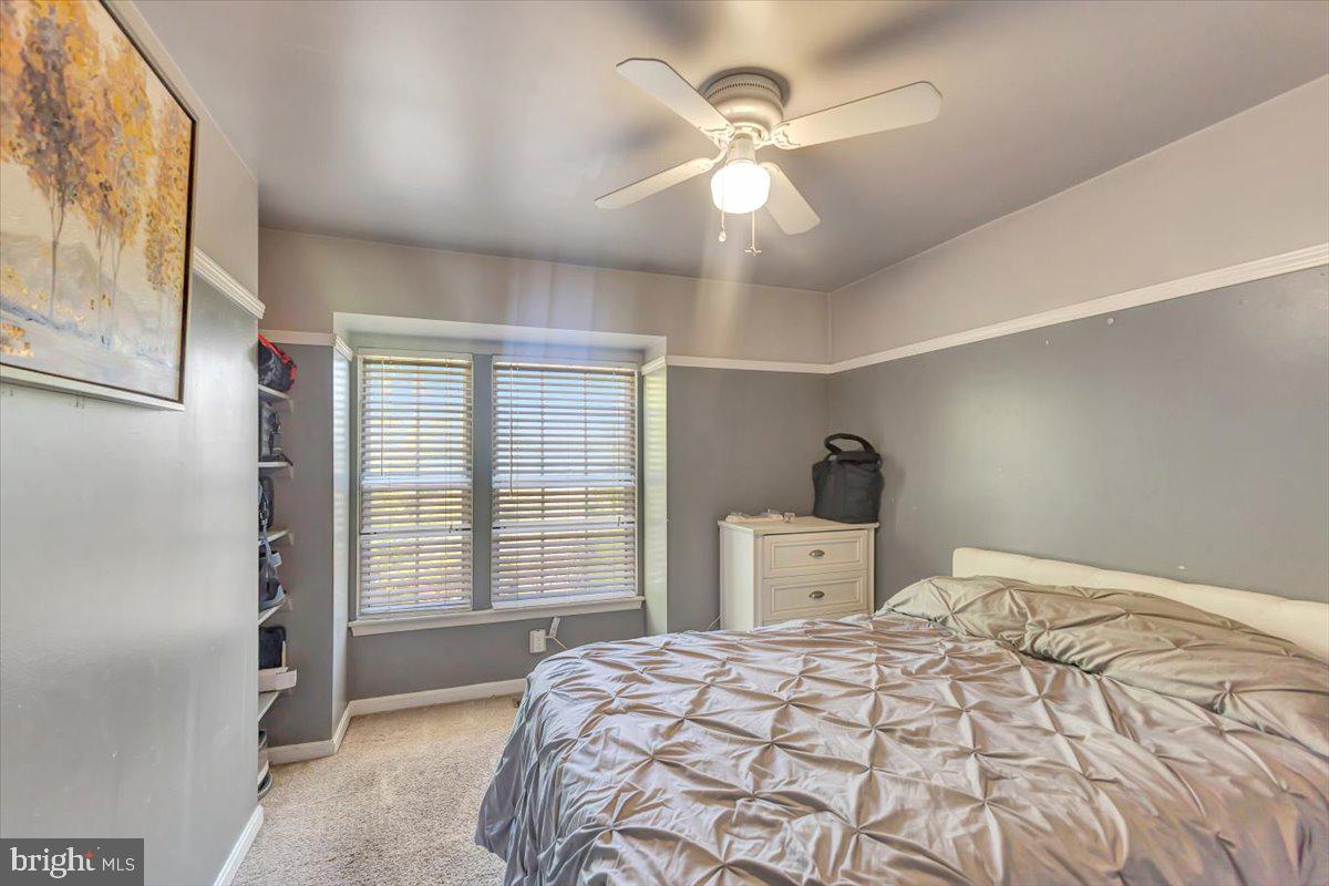 10983 Baskerville Road Reisterstown, MD 21136 - Photo 9 of 21 a bedroom with a large bed and a chandelier