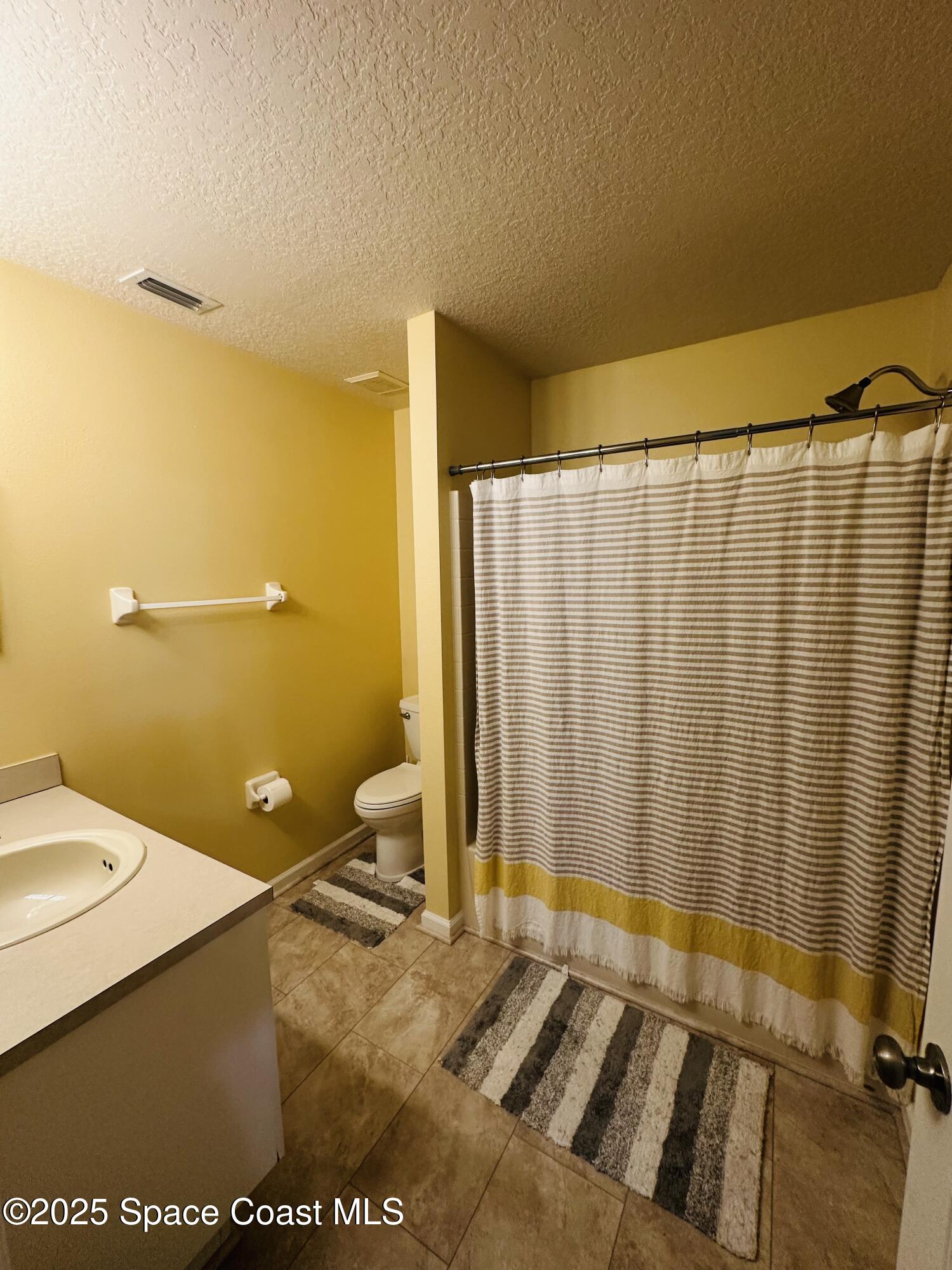 890 Luminary Circle, Unit 103 Melbourne, FL 32901 - Photo 11 of 13 a bathroom with a sink and a mirror