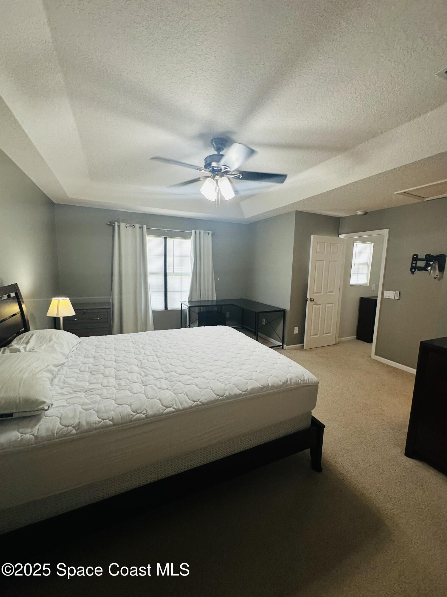 890 Luminary Circle, Unit 103 Melbourne, FL 32901 - Photo 12 of 13 a bedroom with a bed and window