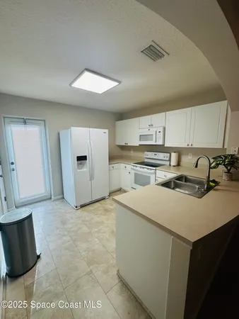 a kitchen with stainless steel appliances a stove a sink and a refrigerator