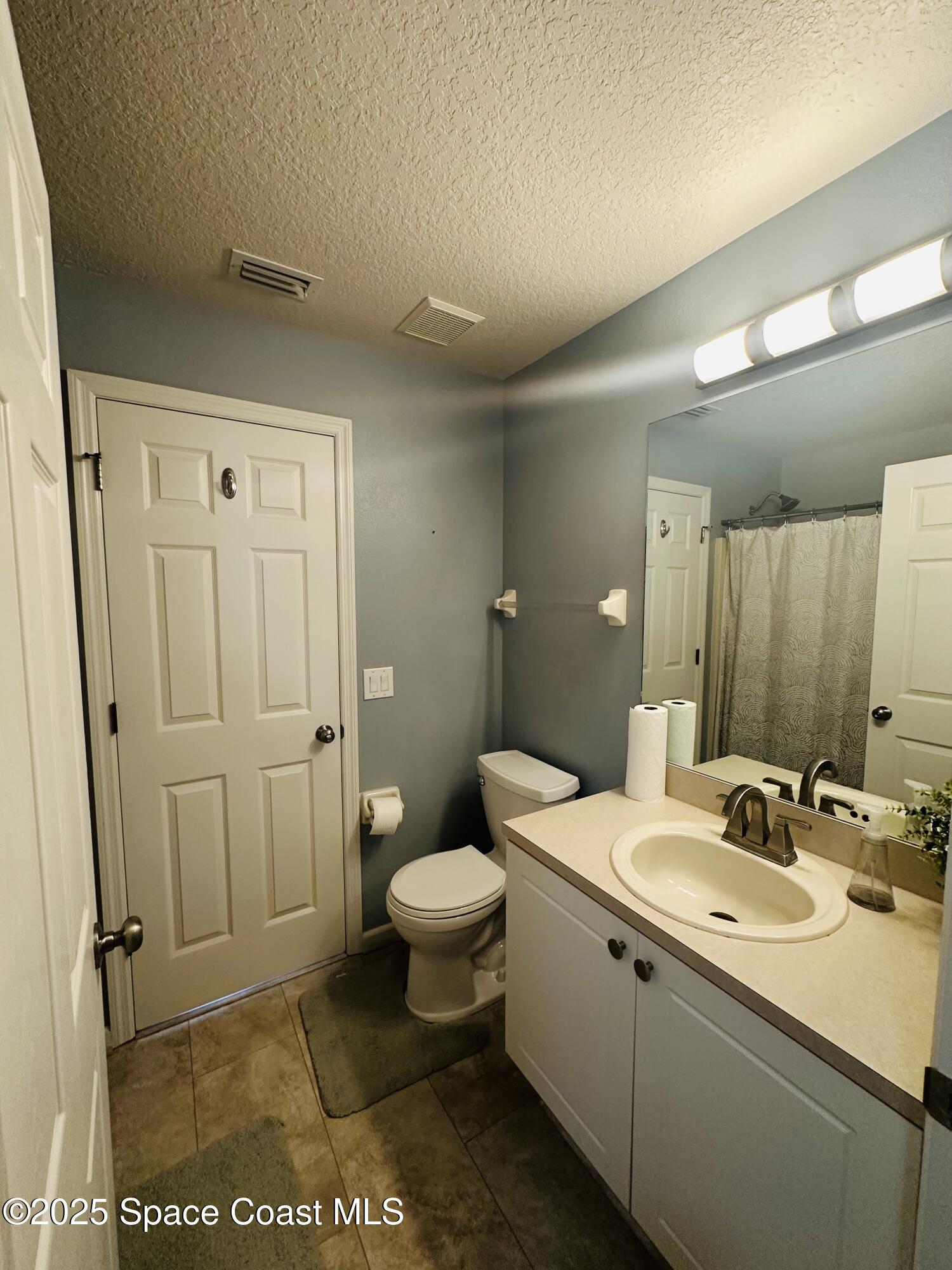 890 Luminary Circle, Unit 103 Melbourne, FL 32901 - Photo 7 of 13 a bathroom with a sink toilet and shower