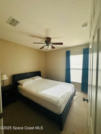 a bedroom with a bed and a table