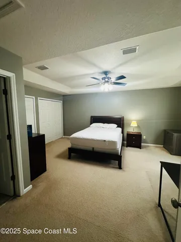 a bedroom with a bed and a dresser