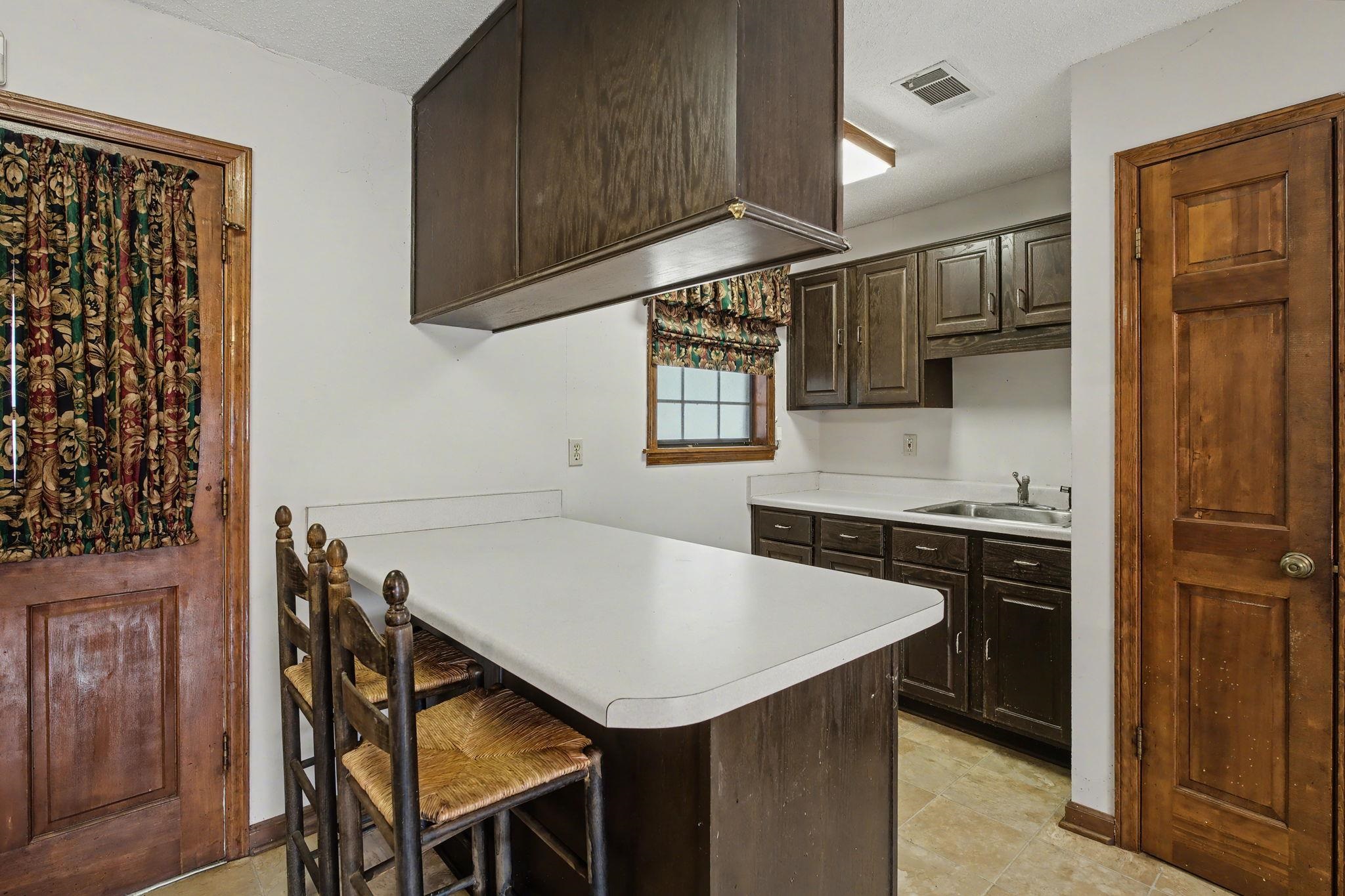 7439 Lexie Gardner Road Bartlett, TN 38002 - Photo 12 of 40 a kitchen with a cabinets a sink and a stove top oven