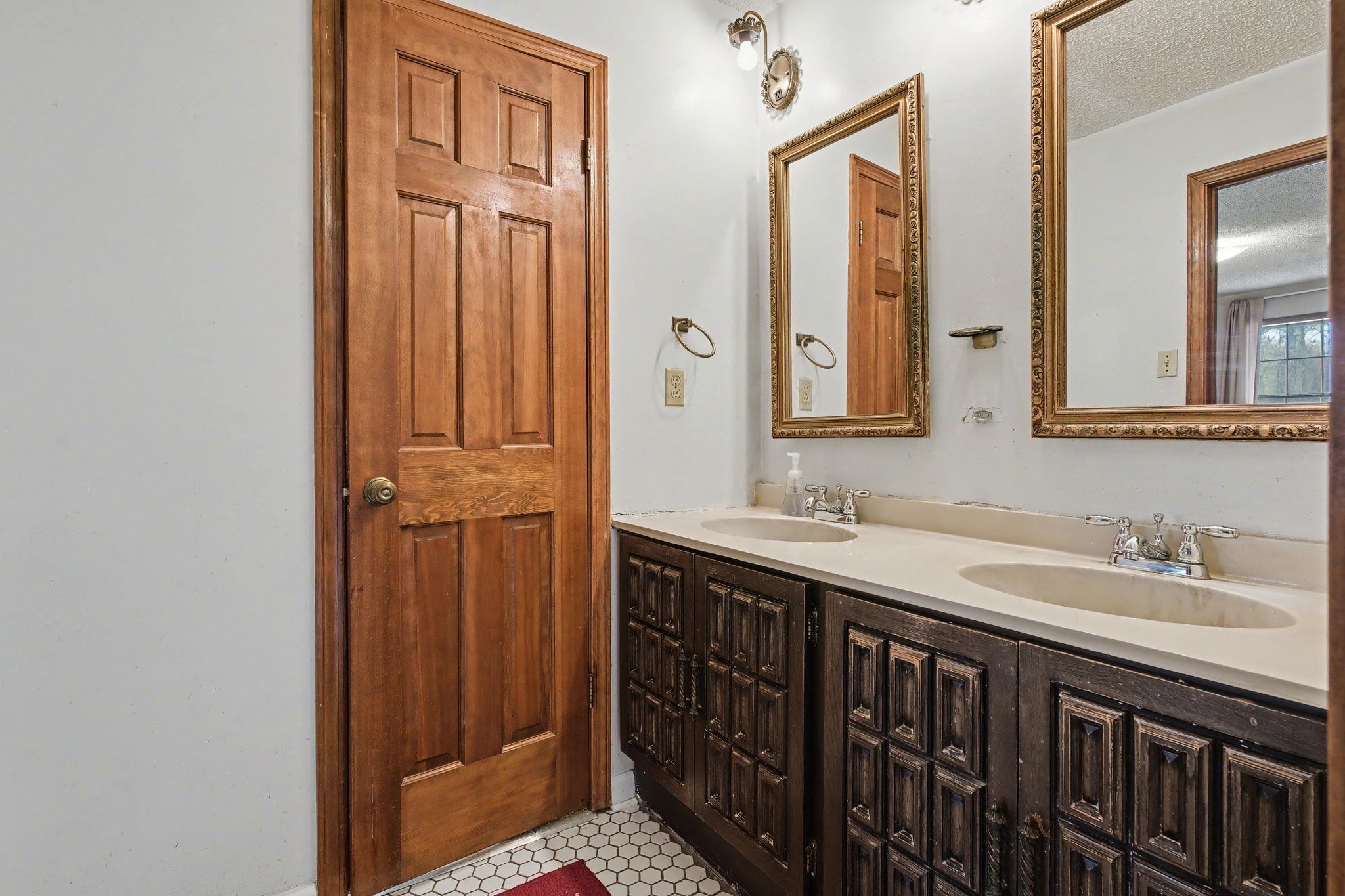 7439 Lexie Gardner Road Bartlett, TN 38002 - Photo 16 of 40 a bathroom with a sink a mirror and a vanity
