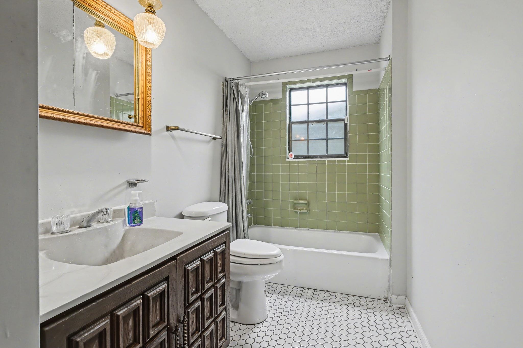 7439 Lexie Gardner Road Bartlett, TN 38002 - Photo 19 of 40 a bathroom with a sink a toilet and shower