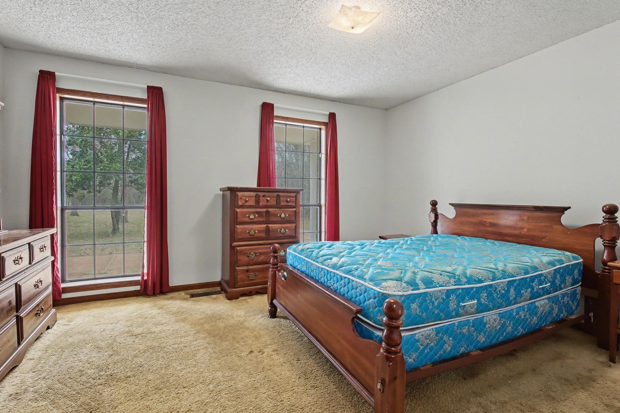 7439 Lexie Gardner Road Bartlett, TN 38002 - Photo 20 of 40 a bed sitting in a bedroom next to a window