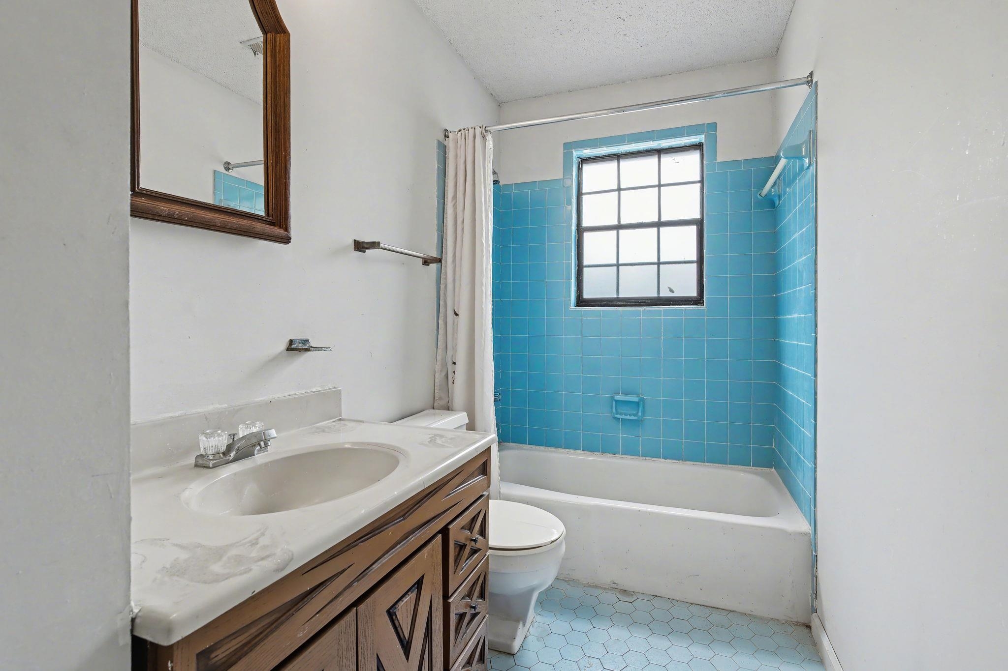 7439 Lexie Gardner Road Bartlett, TN 38002 - Photo 25 of 40 a bathroom with a granite countertop sink a toilet and bathtub