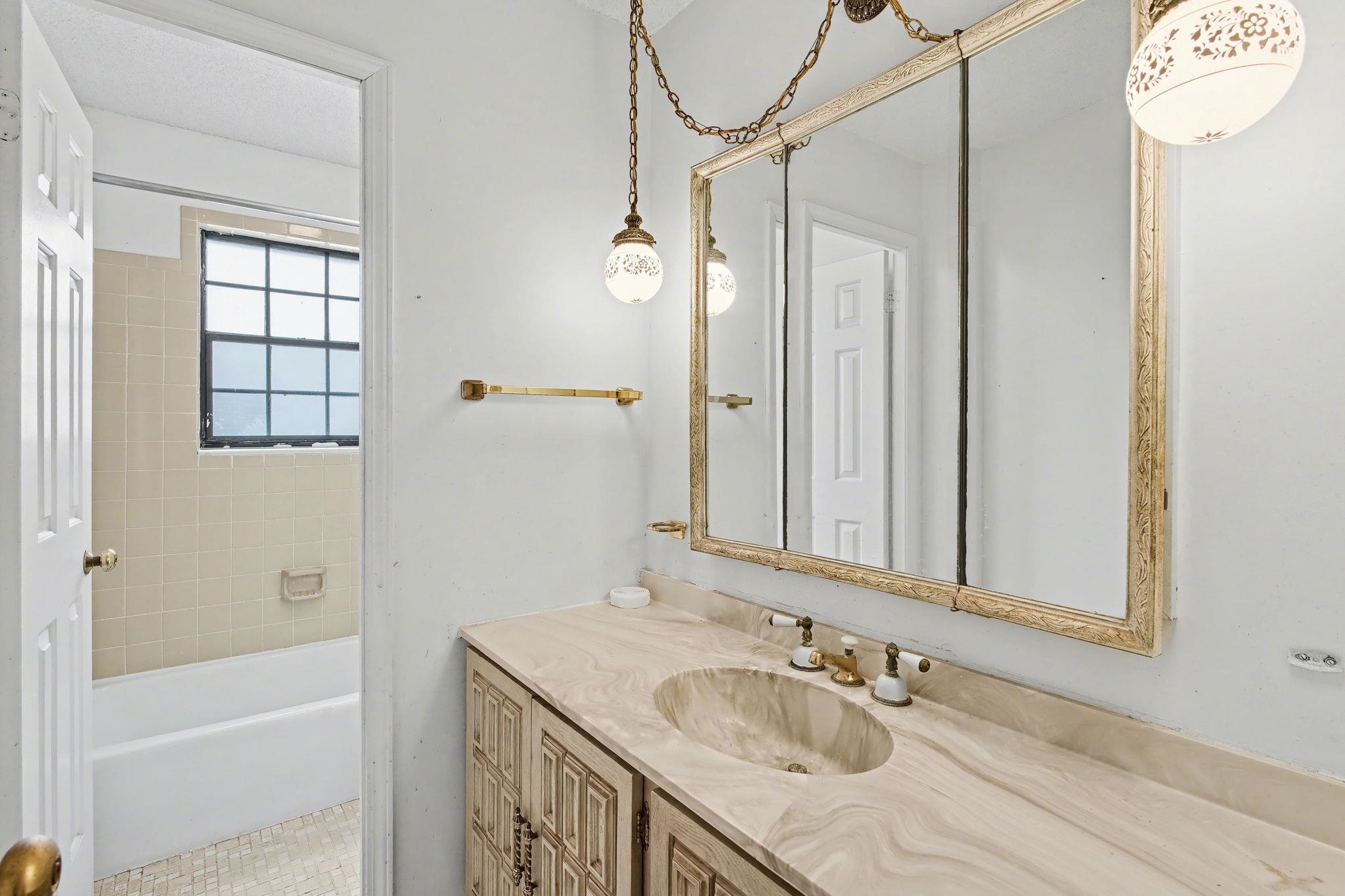 7439 Lexie Gardner Road Bartlett, TN 38002 - Photo 26 of 40 a bathroom with a granite countertop sink mirror and a bathtub