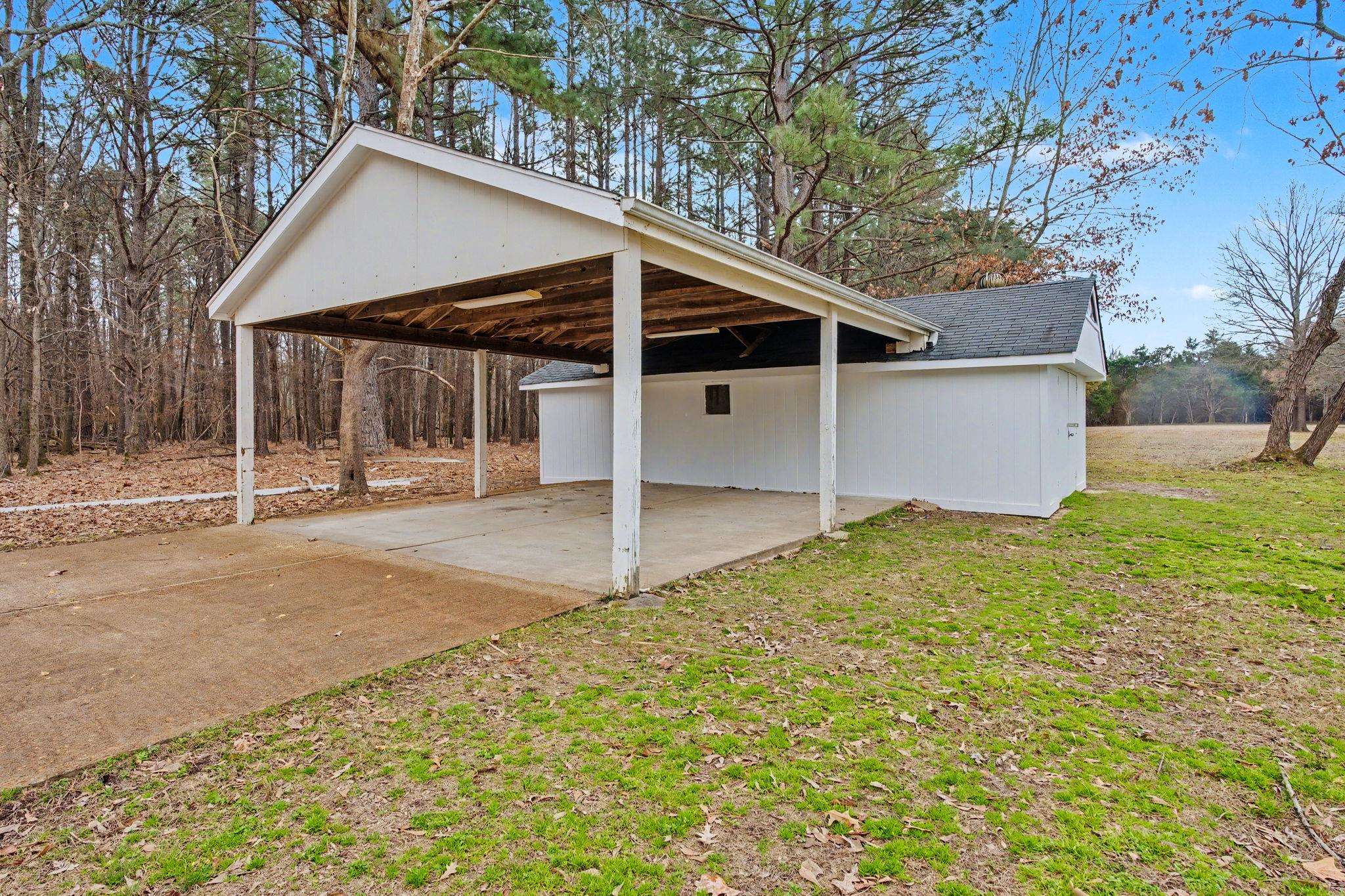 7439 Lexie Gardner Road Bartlett, TN 38002 - Photo 37 of 40 a view of a white house with a yard and garage