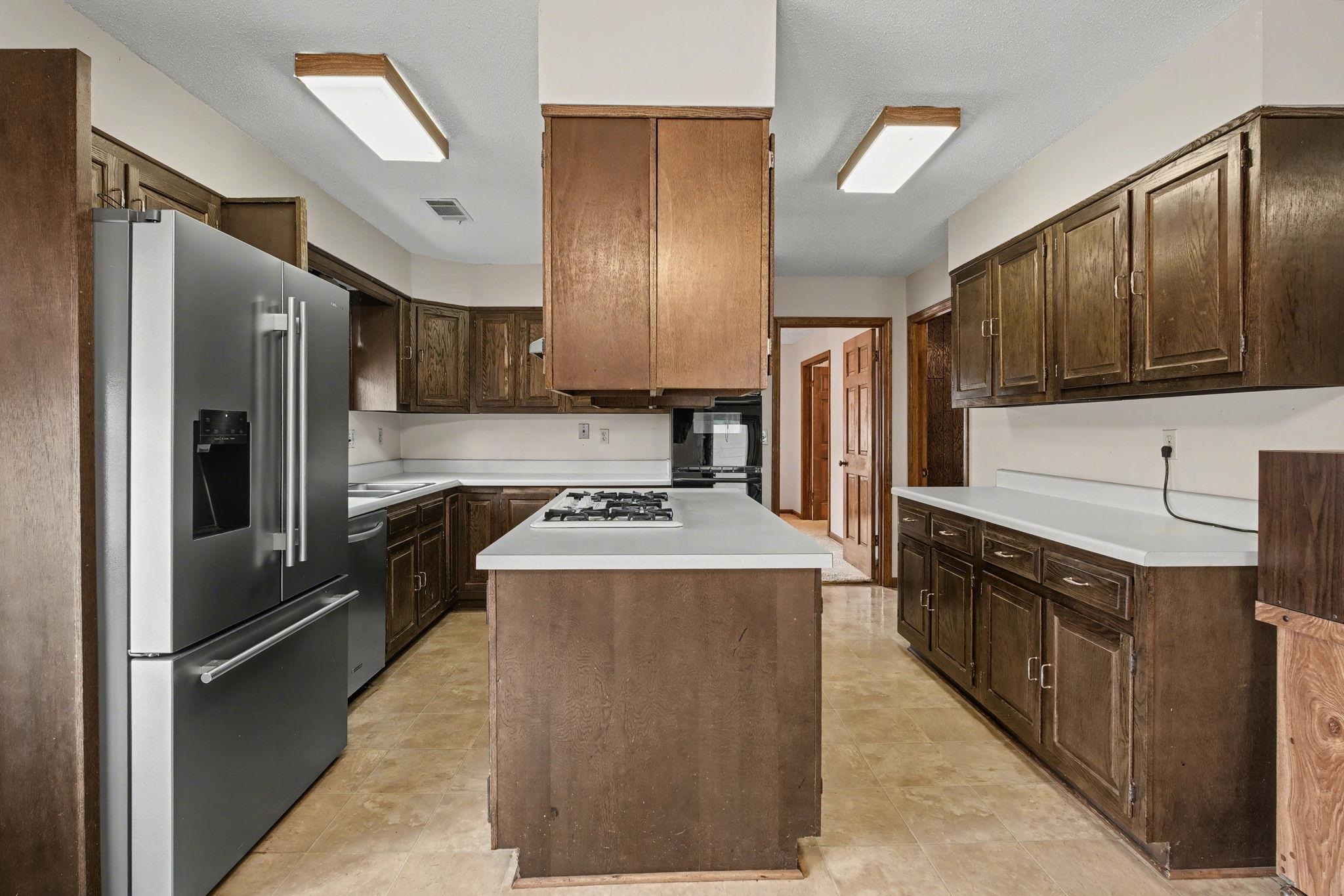 7439 Lexie Gardner Road Bartlett, TN 38002 - Photo 8 of 40 a kitchen with stainless steel appliances granite countertop a refrigerator a stove and a sink