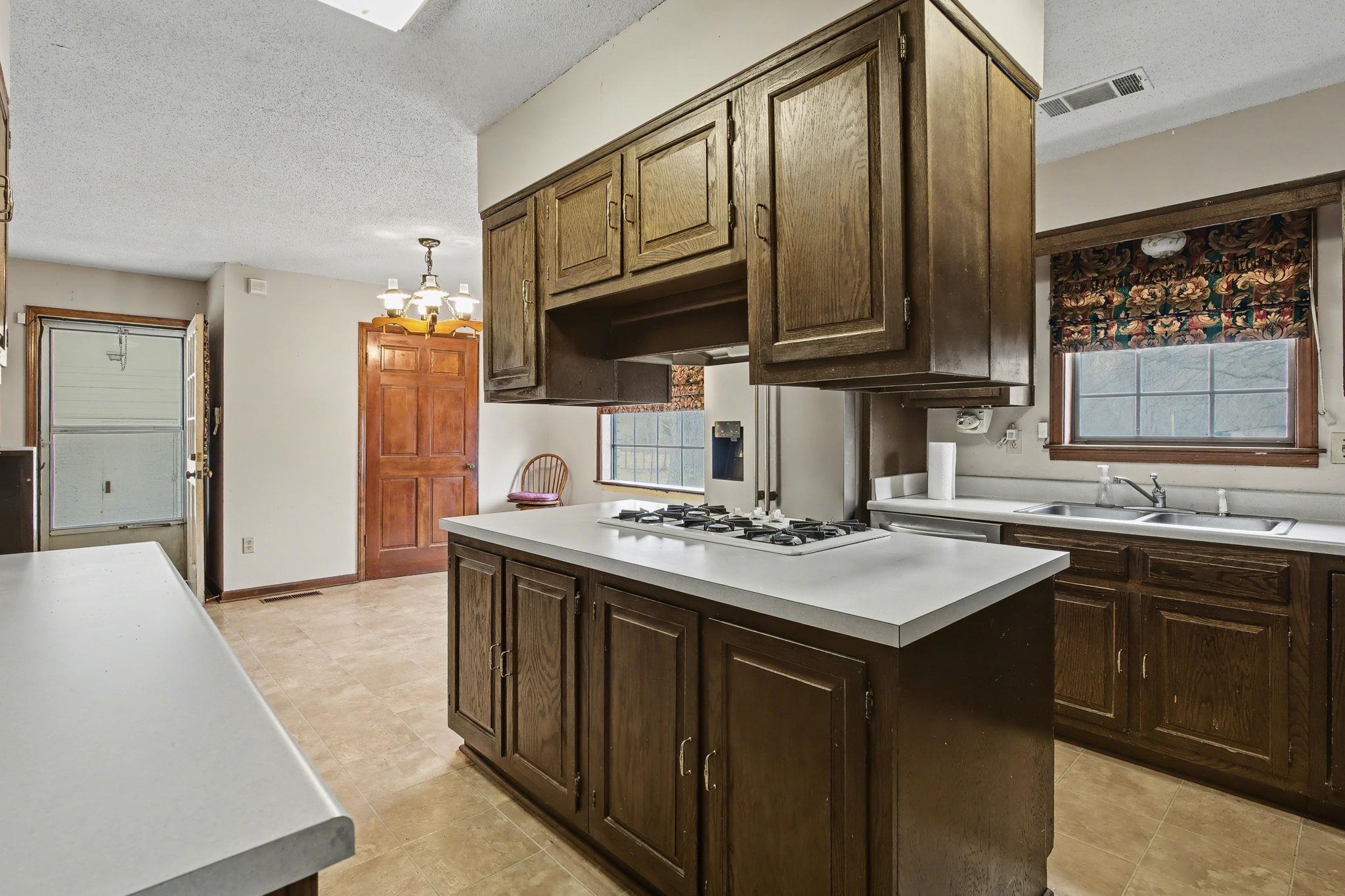 7439 Lexie Gardner Road Bartlett, TN 38002 - Photo 9 of 40 a kitchen with stainless steel appliances granite countertop a sink stove and refrigerator