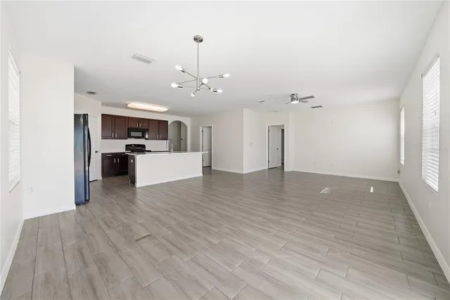 a view of a kitchen with a sink and wooden floor