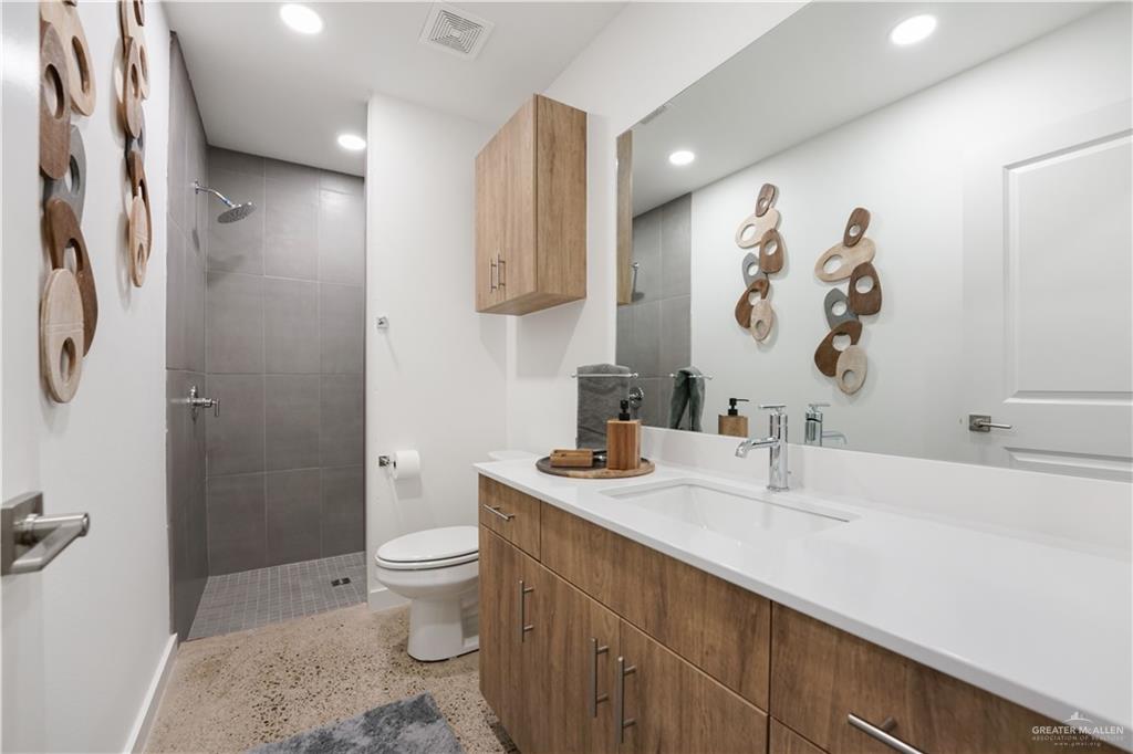 4005 Jenna Lane, Unit A Weslaco, TX 78599 - Photo 11 of 28 a bathroom with a sink a toilet and shower curtain