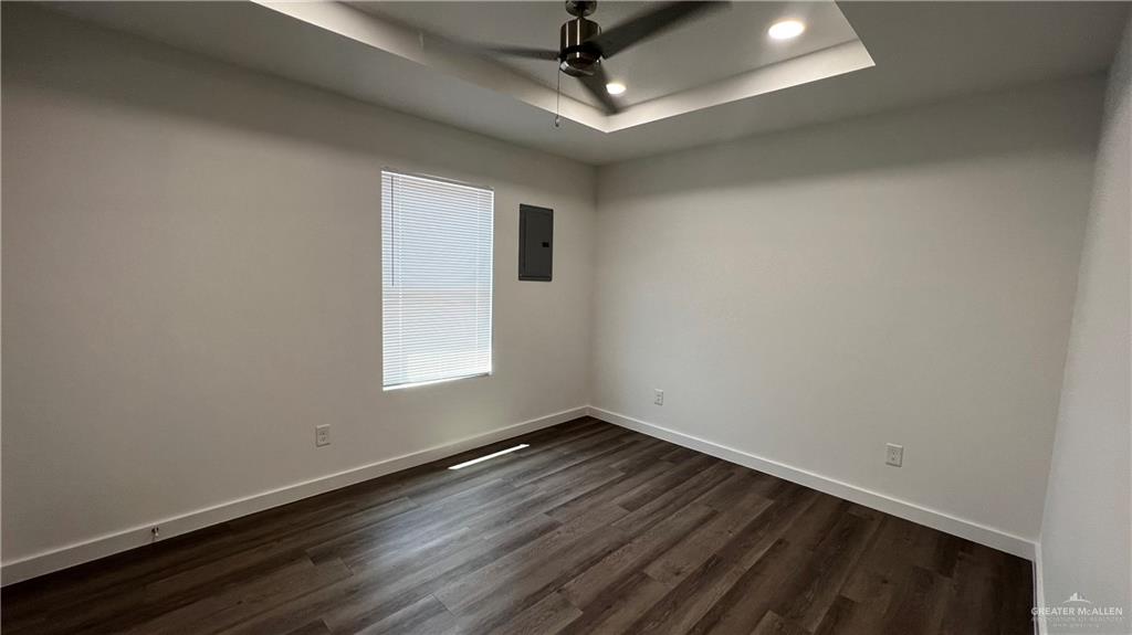 4005 Jenna Lane, Unit A Weslaco, TX 78599 - Photo 12 of 28 an empty room with wooden floor and windows