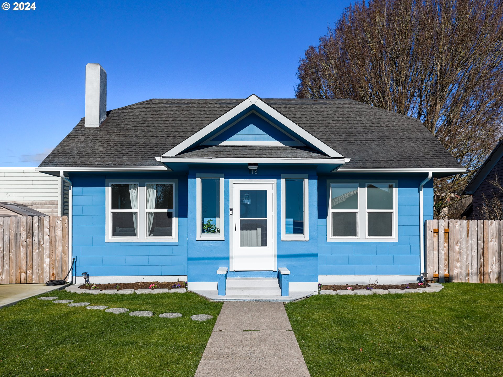 118 Main Street Southwest Ilwaco, WA 98624 - Photo 1 of 44 a front view of a house with a garden