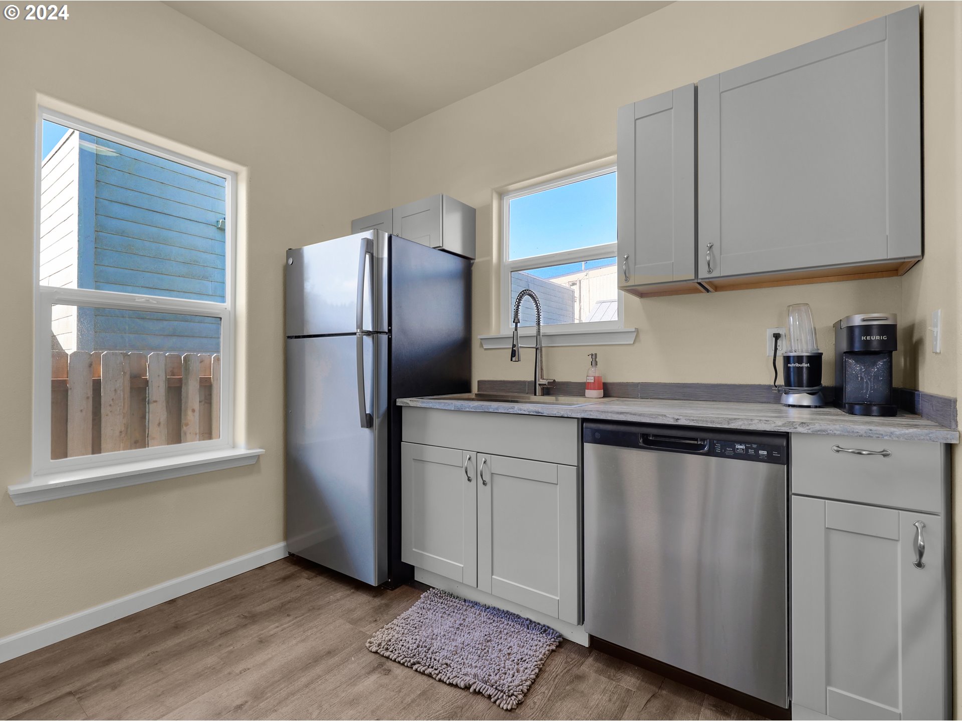 118 Main Street Southwest Ilwaco, WA 98624 - Photo 15 of 44 a kitchen with stainless steel appliances granite countertop a refrigerator sink and microwave