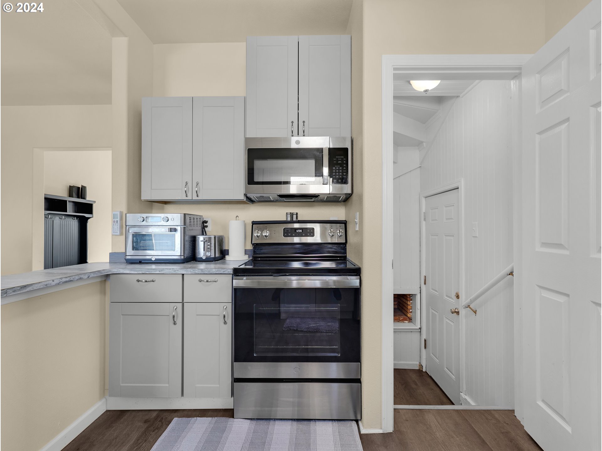 118 Main Street Southwest Ilwaco, WA 98624 - Photo 18 of 44 a kitchen with stainless steel appliances granite countertop a stove and a refrigerator