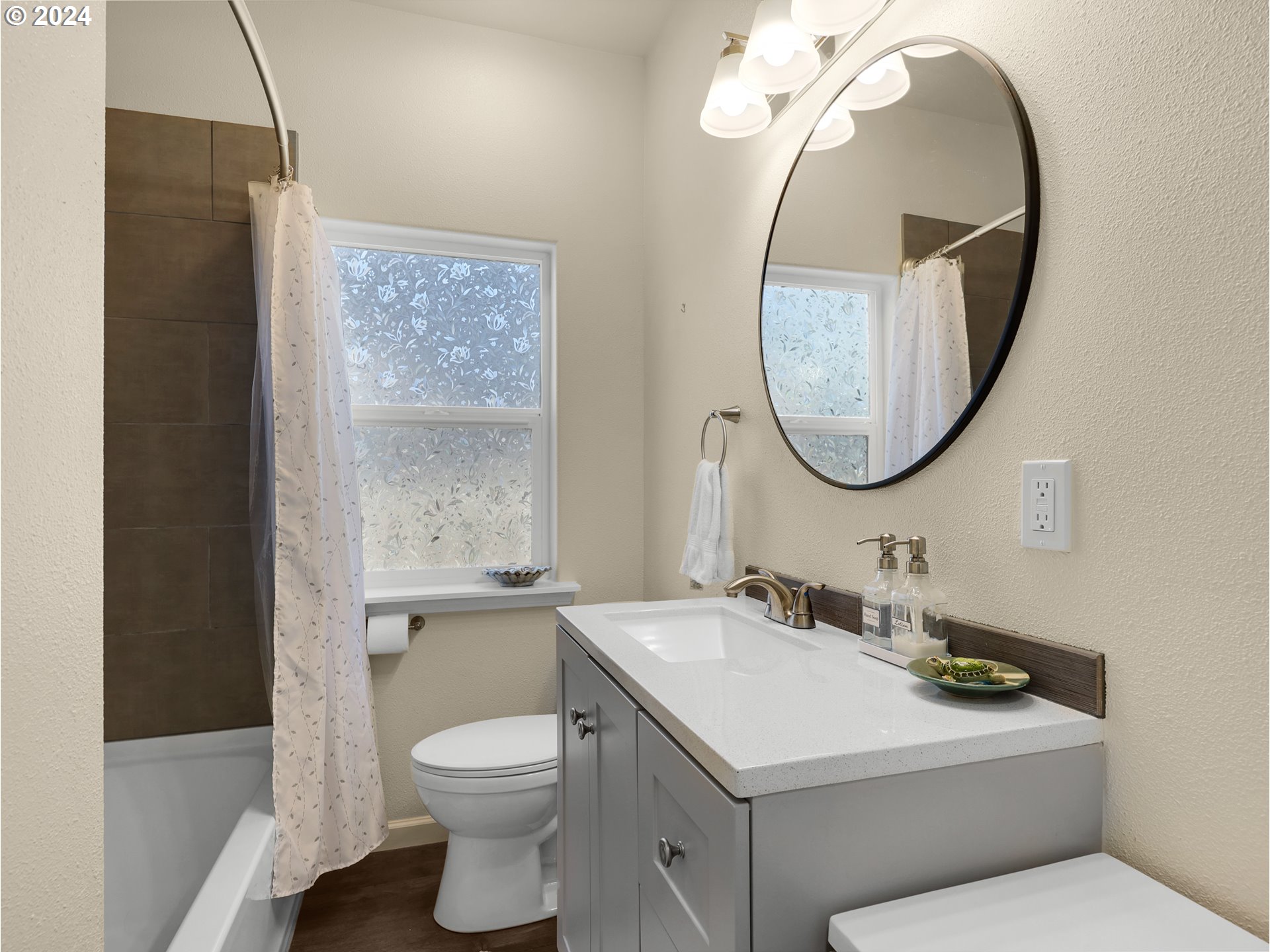 118 Main Street Southwest Ilwaco, WA 98624 - Photo 21 of 44 a bathroom with a toilet a sink a mirror and a window