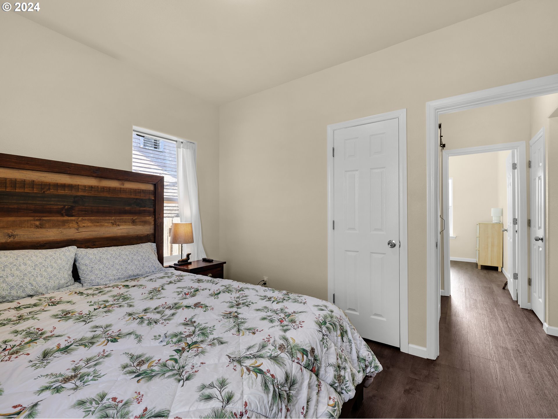 118 Main Street Southwest Ilwaco, WA 98624 - Photo 26 of 44 a bedroom with a bed and wooden floor