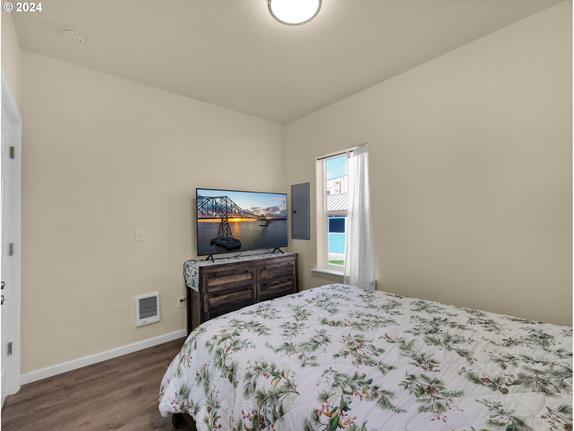 118 Main Street Southwest Ilwaco, WA 98624 - Photo 27 of 44 a bedroom with a bed and a flat screen tv