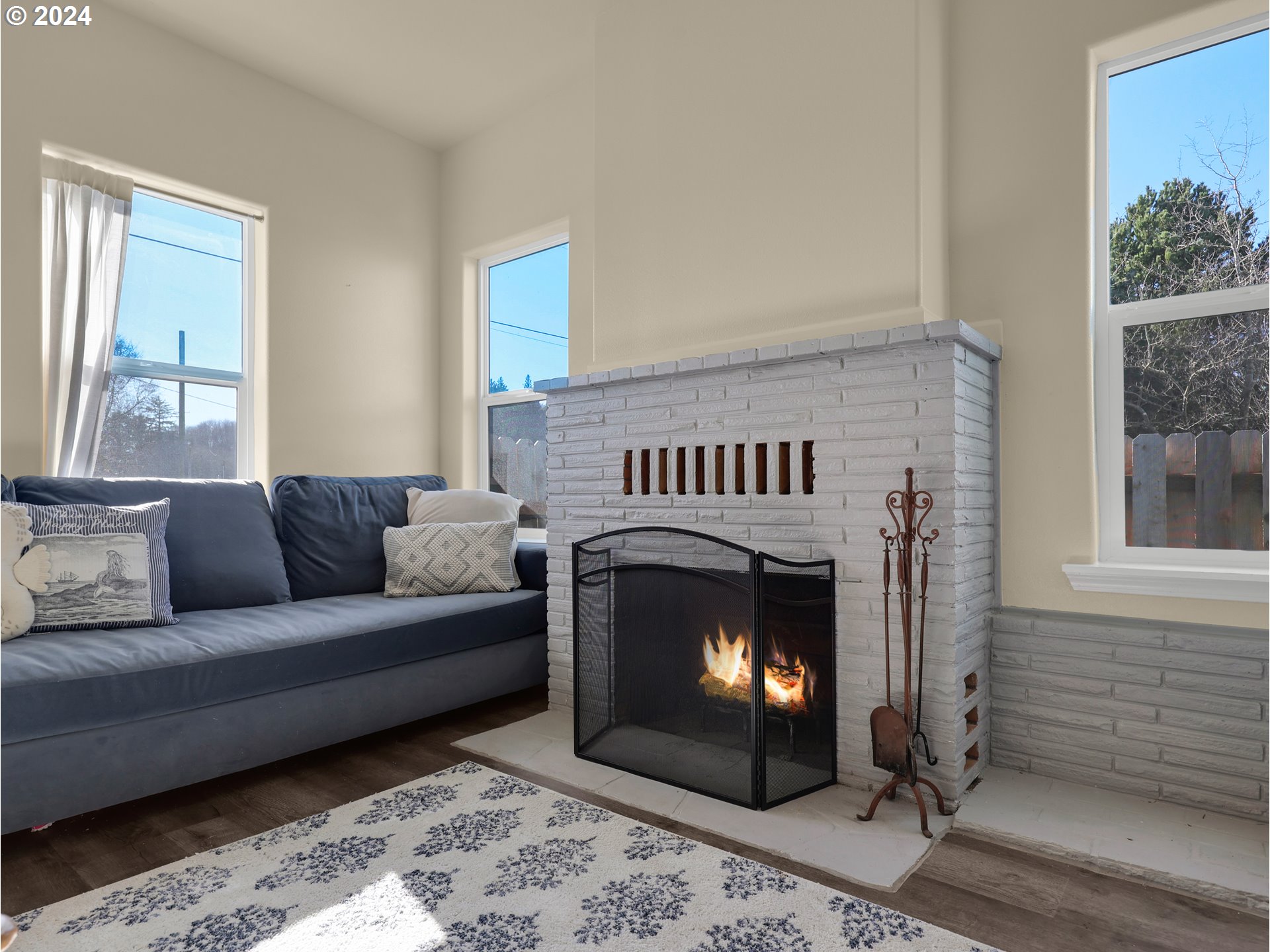 118 Main Street Southwest Ilwaco, WA 98624 - Photo 8 of 44 a living room with furniture a window and a fireplace