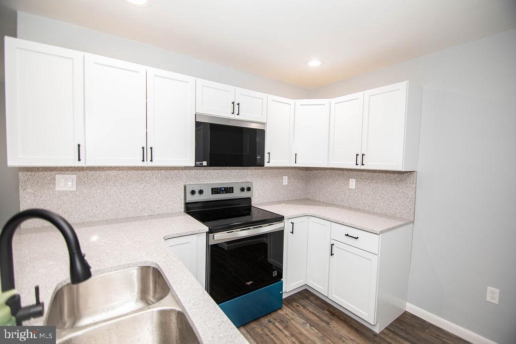 245 Windy Hill Road Shermans Dale, PA 17090 - Photo 22 of 42 a kitchen with stainless steel appliances a stove a sink a microwave and cabinets