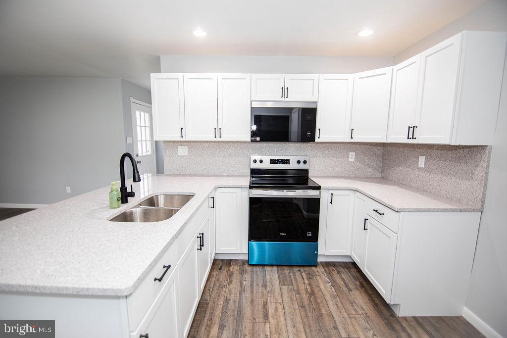 245 Windy Hill Road Shermans Dale, PA 17090 - Photo 25 of 42 a kitchen with sink a microwave and cabinets