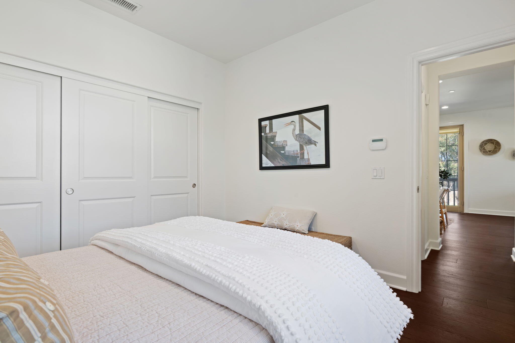 7863 Whimbrel Lane Goleta, CA 93117 - Photo 14 of 22 a bedroom with a bed and wooden floor