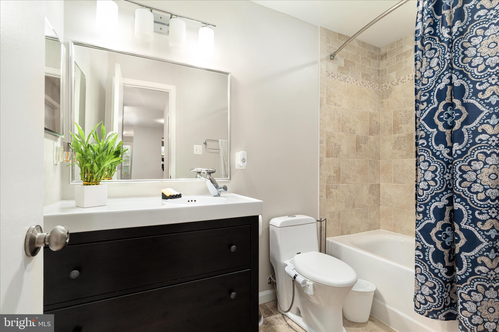 10198 Oakton Terrace Road Oakton, VA 22124 - Photo 13 of 22 a bathroom with a sink toilet and shower
