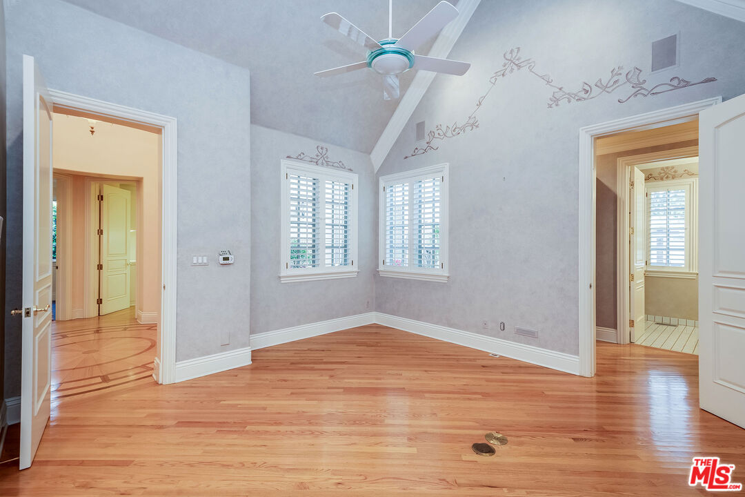 10045 Valley Spring Lane Toluca Lake, CA 91602 - Photo 18 of 36 a view of empty room with wooden floor and fan