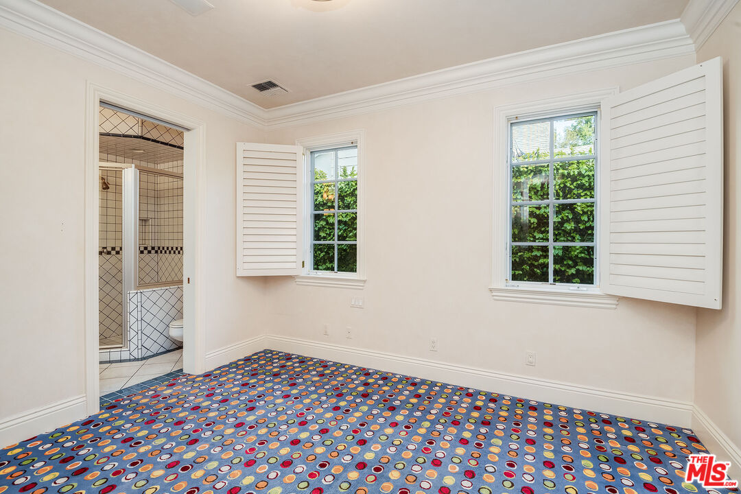 10045 Valley Spring Lane Toluca Lake, CA 91602 - Photo 20 of 36 a bedroom with a bed and a window