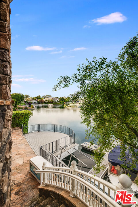 10045 Valley Spring Lane Toluca Lake, CA 91602 - Photo 27 of 36 a view of a lake with couches and city view