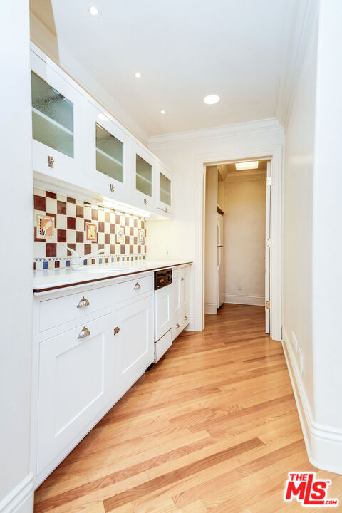 10045 Valley Spring Lane Toluca Lake, CA 91602 - Photo 30 of 36 a view of a hallway with wooden floor
