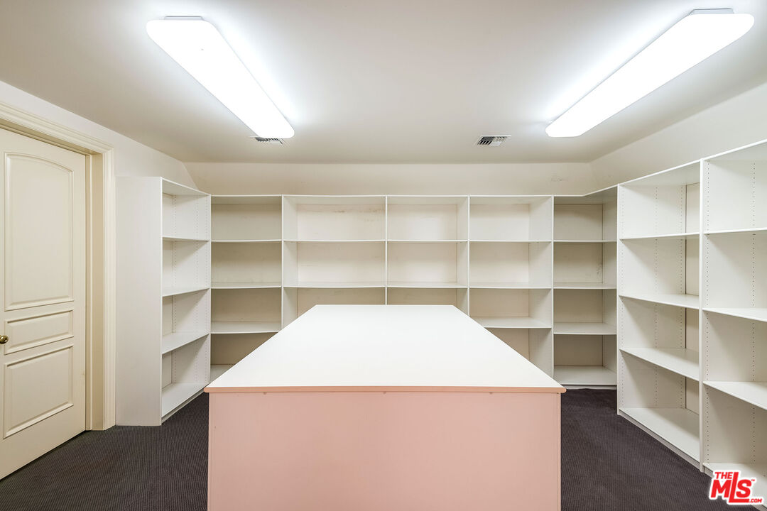 10045 Valley Spring Lane Toluca Lake, CA 91602 - Photo 33 of 36 a view of a room with cabinets and wooden floor