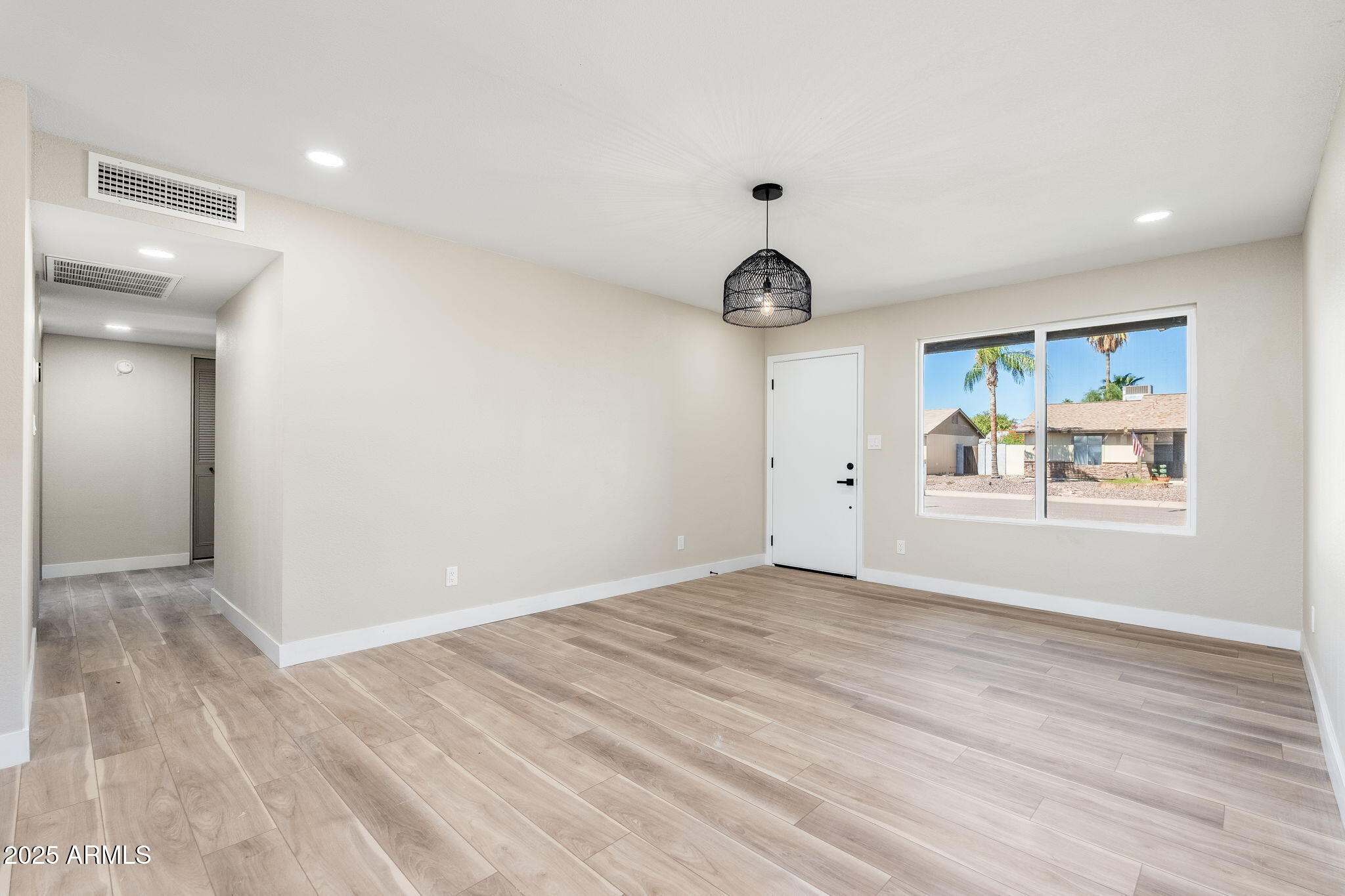 1805 West Cheyenne Drive Chandler, AZ 85224 - Photo 11 of 32 a view of an empty room with window and wooden floor