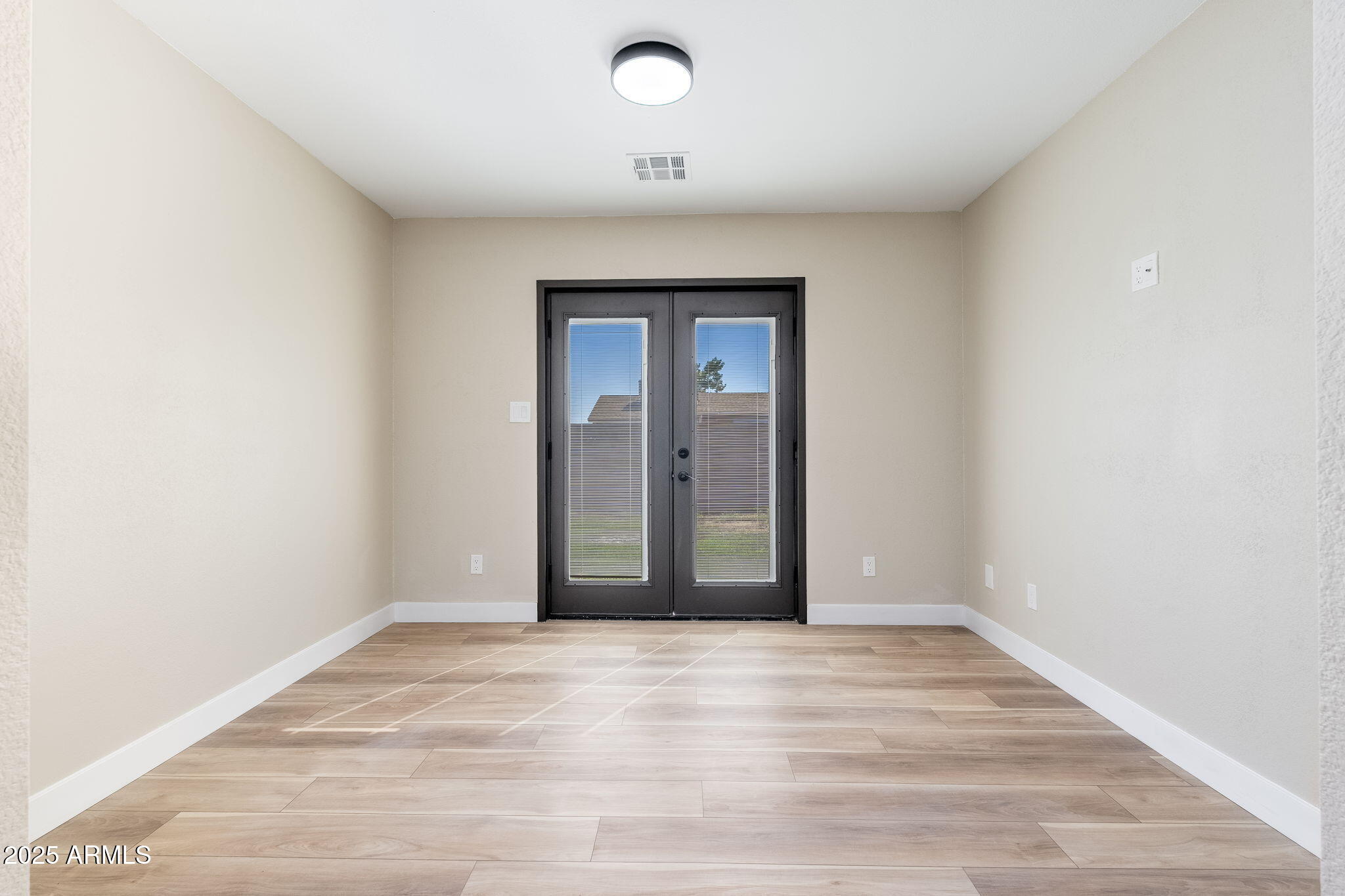 1805 West Cheyenne Drive Chandler, AZ 85224 - Photo 14 of 32 an empty room with wooden floor and windows