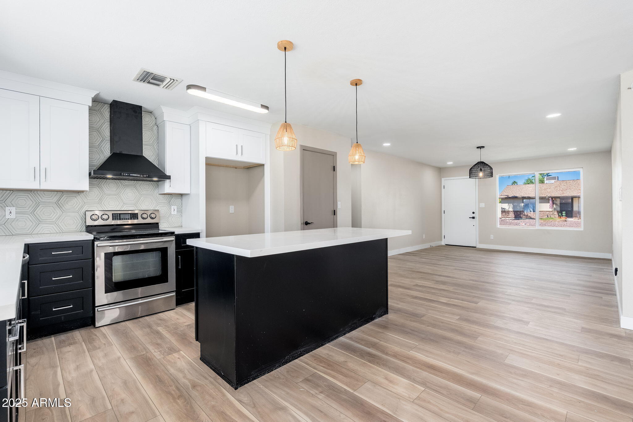 1805 West Cheyenne Drive Chandler, AZ 85224 - Photo 4 of 32 a kitchen with stainless steel appliances kitchen island a refrigerator stove and sink