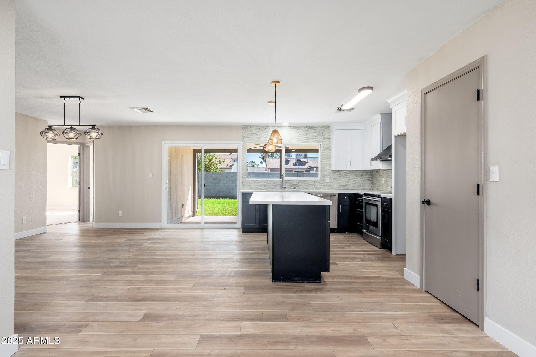 1805 West Cheyenne Drive Chandler, AZ 85224 - Photo 8 of 32 a kitchen with kitchen island a sink cabinets and wooden floor