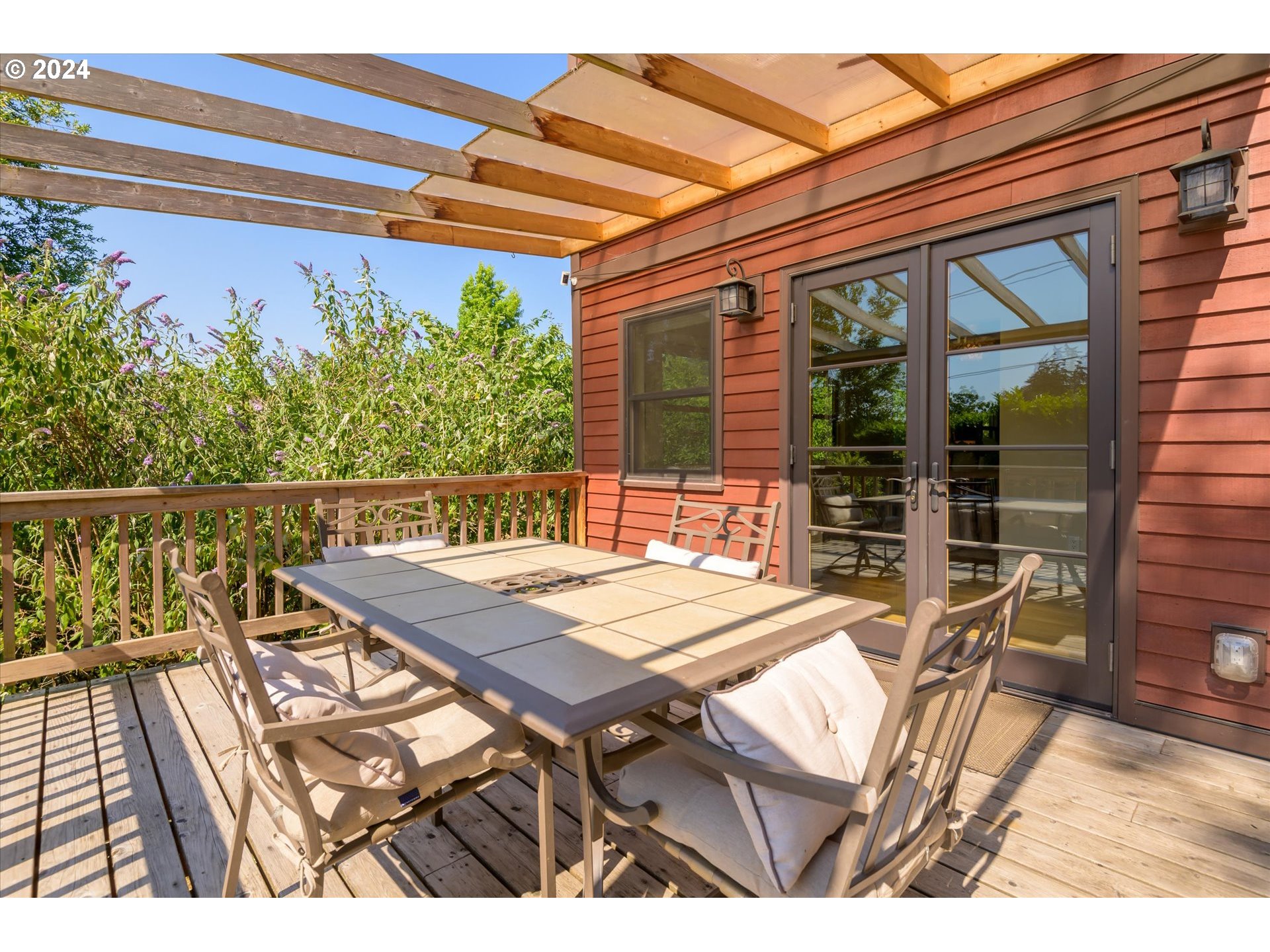 2602 Agate Street Eugene, OR 97403 - Photo 16 of 37 a view of a patio with table and chairs with wooden floor and fence