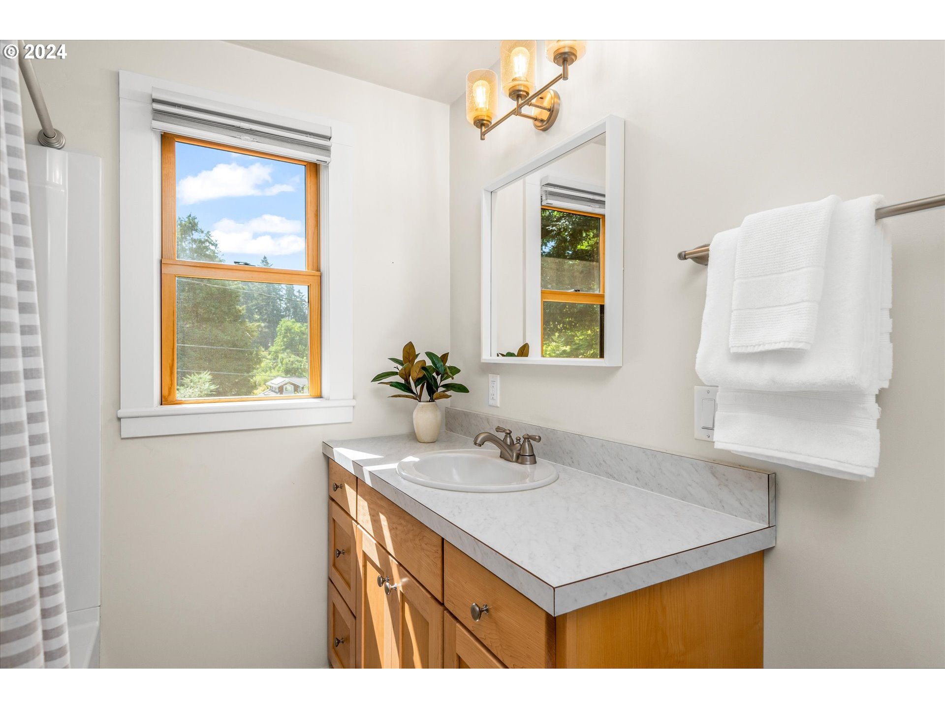 2602 Agate Street Eugene, OR 97403 - Photo 30 of 37 a bathroom with a sink a vanity and a window