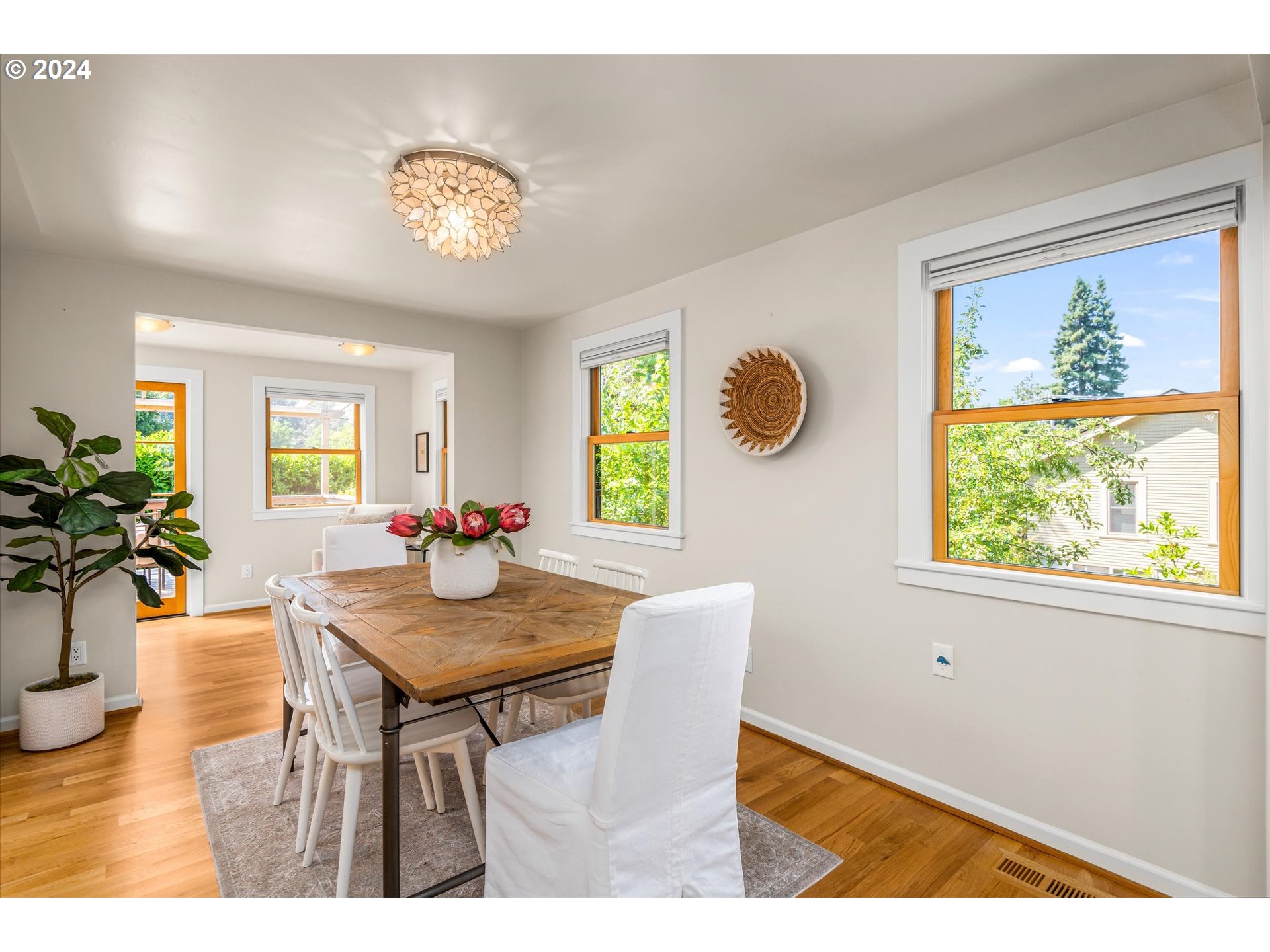 2602 Agate Street Eugene, OR 97403 - Photo 6 of 37 a view of a dining room with furniture wooden floor and a chandelier