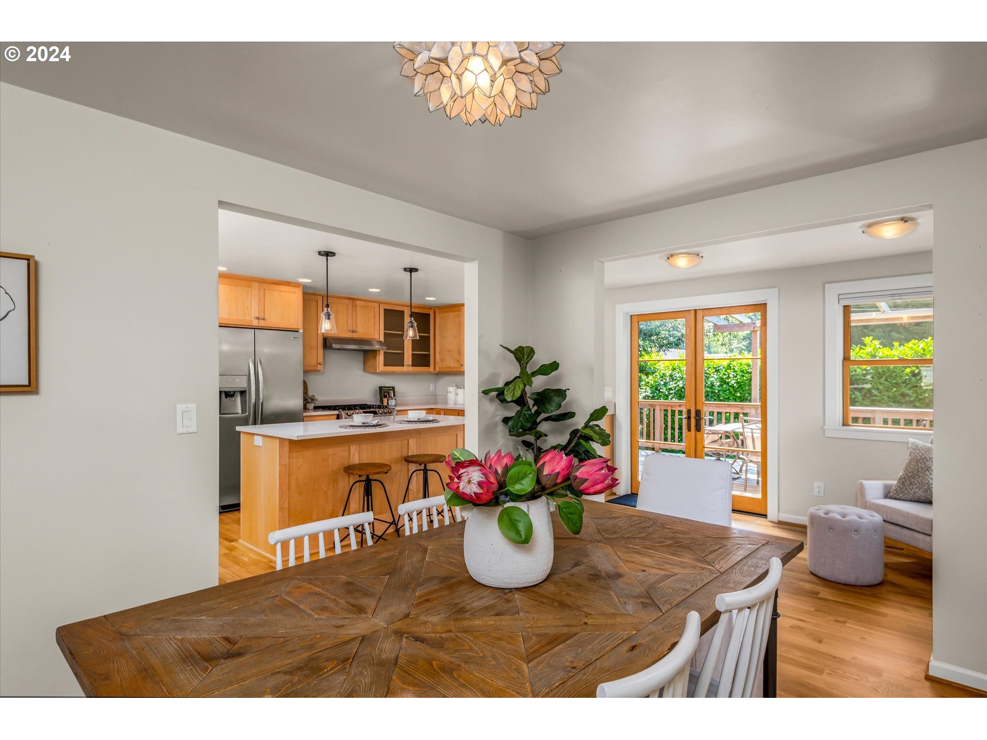 2602 Agate Street Eugene, OR 97403 - Photo 8 of 37 a room with kitchen island a potted plant and a large window