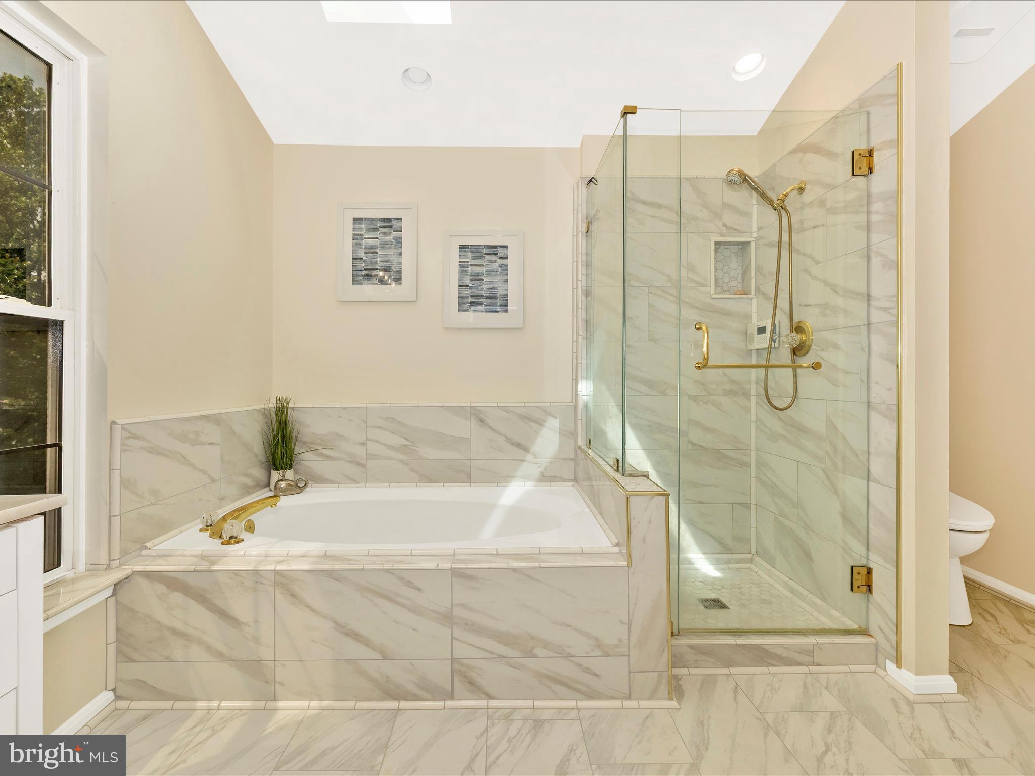 21405 Emerald Drive Germantown, MD 20876 - Photo 16 of 51 a bathroom with a glass shower door