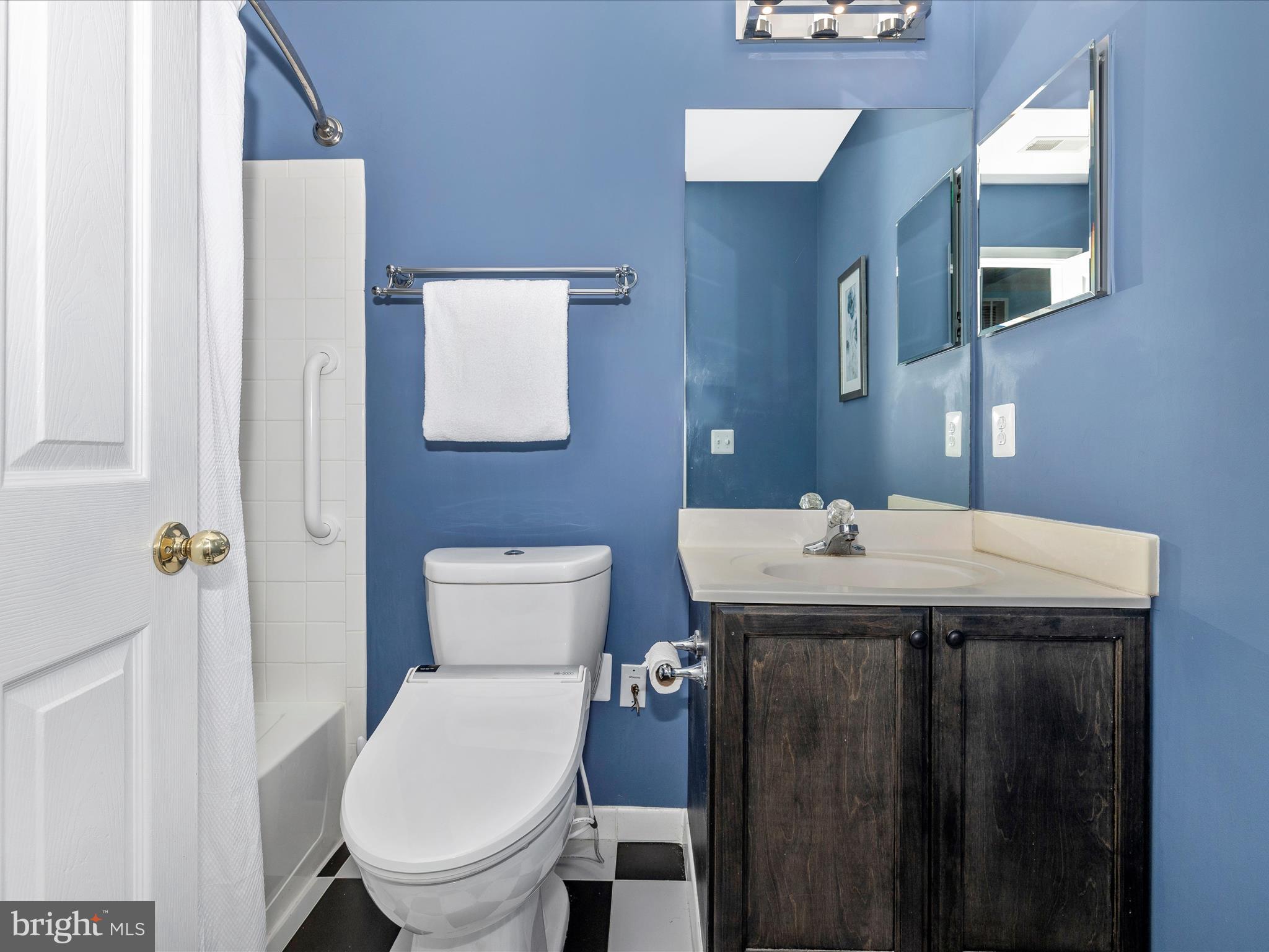 21405 Emerald Drive Germantown, MD 20876 - Photo 30 of 51 a bathroom with a toilet a sink and mirror