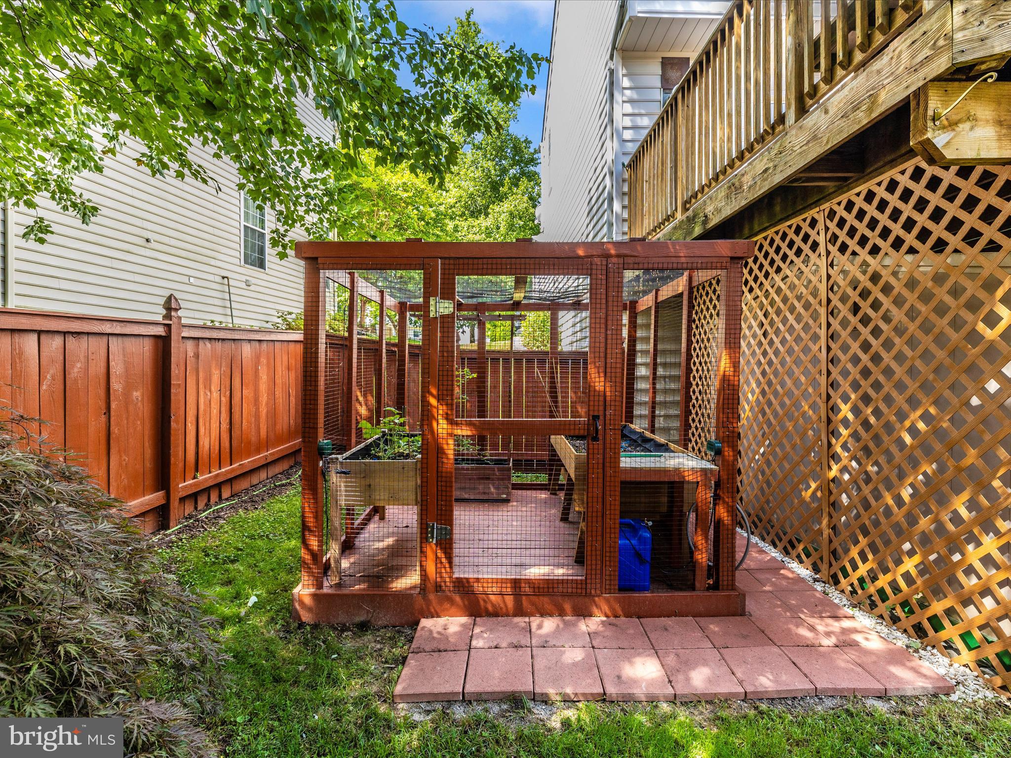 21405 Emerald Drive Germantown, MD 20876 - Photo 39 of 51 a view of a backyard with wooden fence and a bench