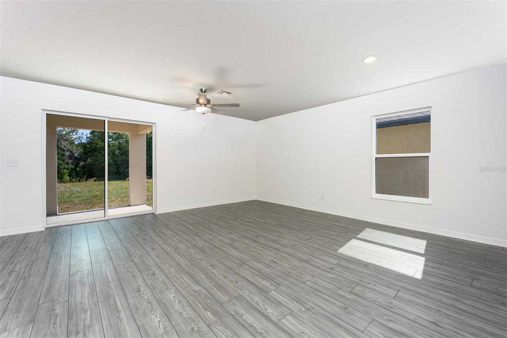 3207 Seville Street Lake Alfred, FL 33850 - Photo 7 of 14 a view of empty room with wooden floor and fan