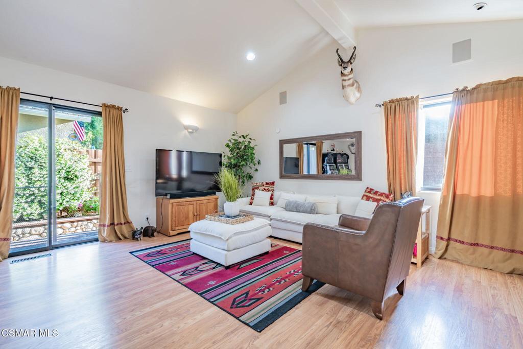 6078 Peppertree Lane Simi Valley, CA 93063 - Photo 9 of 59 a living room with furniture a large window and a wooden floor